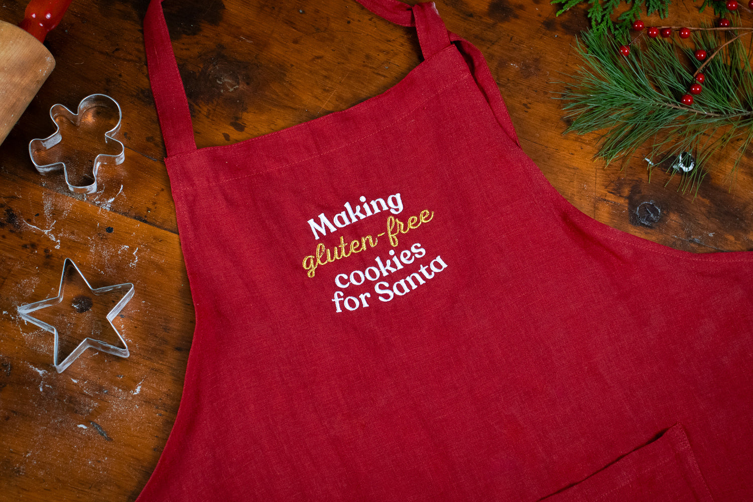 Close-up of apron on a table with embroidery "Making gluten-free cookies for Santa".